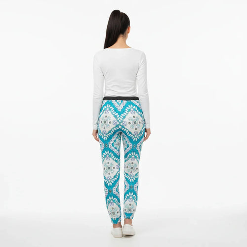 Back view of woman in white top and blue patterned pants, Ivorynn women's fashion