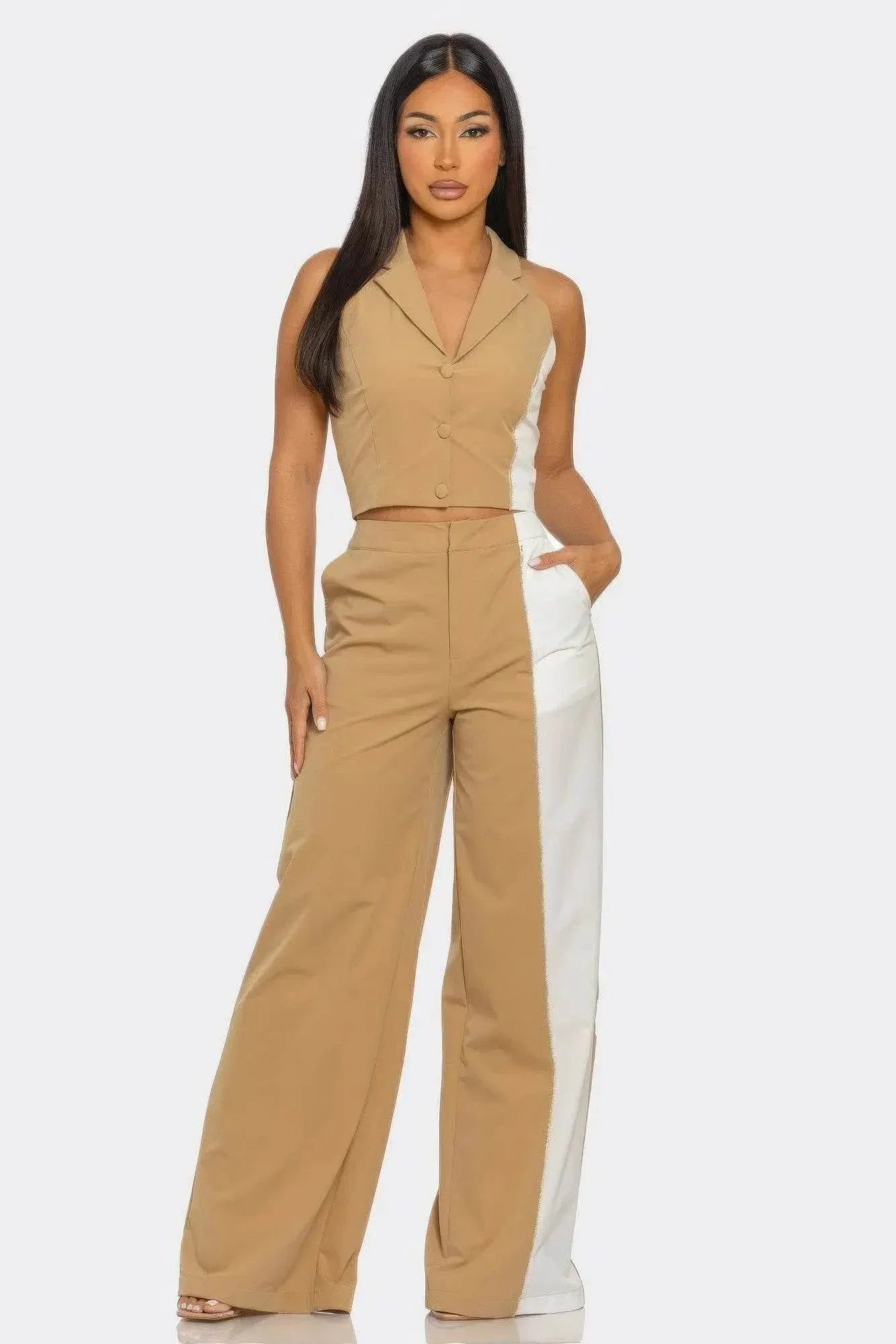 Woman modeling a two-tone tan and white sleeveless pantsuit, stylish modern fashion from IVORYNN