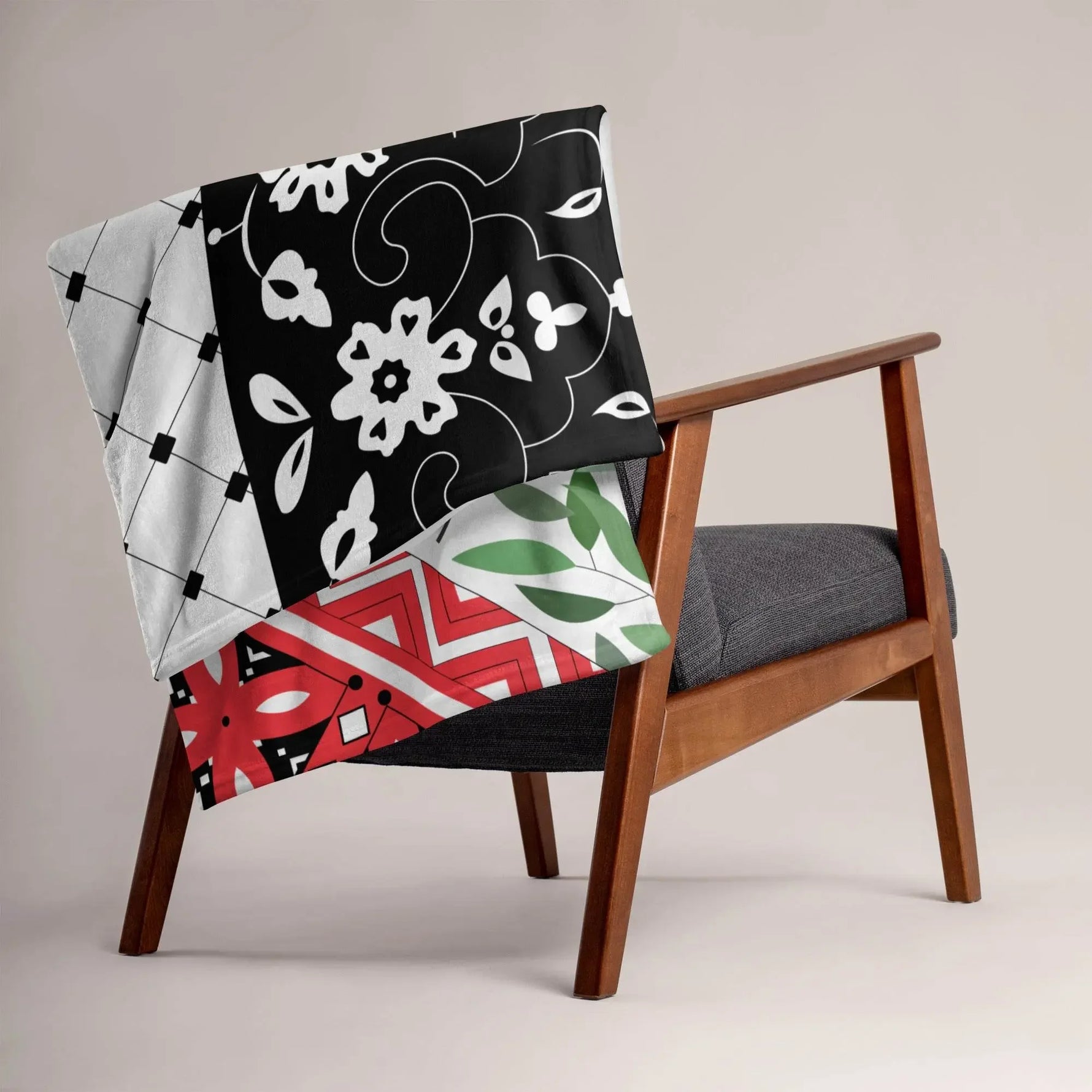 Floral and geometric patterned throw blanket draped on a modern wooden chair at Ivorynn.