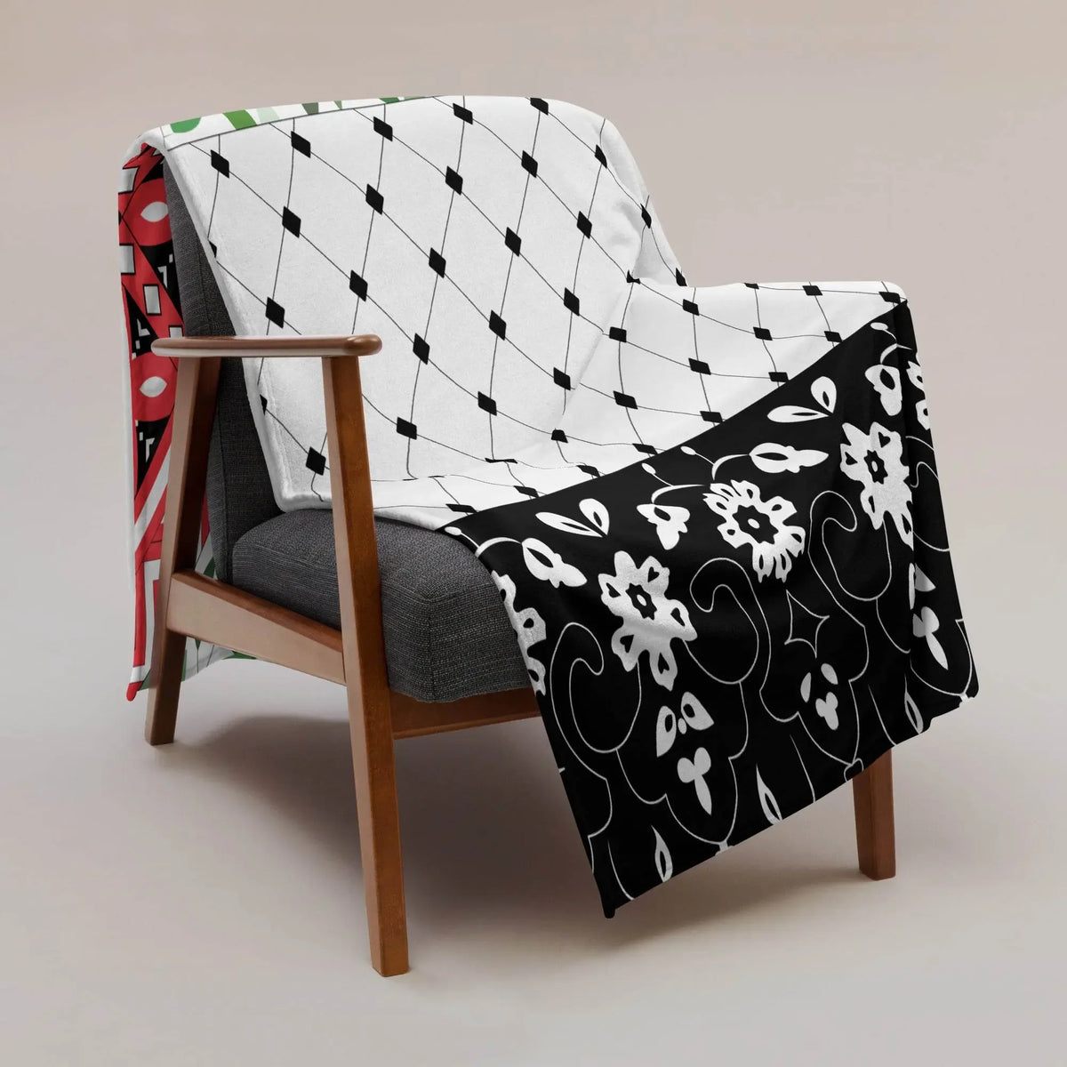 Black and white floral throw blanket with geometric patterns draped over a modern armchair at Ivorynn