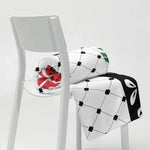 Floral throw blanket with grid pattern and colorful accents draped on a white chair, Ivorynn home decor