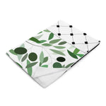 Ivorynn floral throw blanket with green leaves and black grid pattern on white background