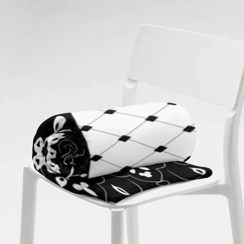 Black and white floral throw blanket with geometric pattern on white chair from Ivorynn