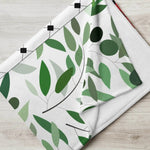 Ivorynn floral throw blanket with green leaf pattern on white background, modern home decor