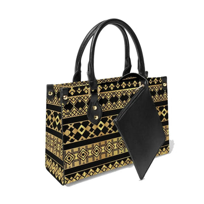 Ivorynn tote bag with geometric gold and black pattern, black handles, and attached pouch.