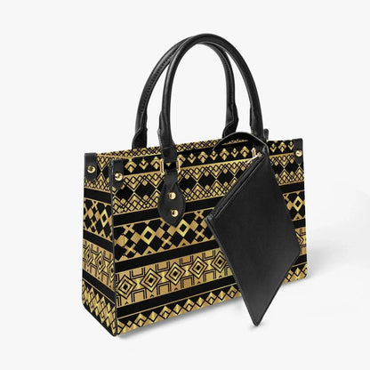 Ivorynn tote bag with black leather handles, geometric gold pattern, and matching inner pouch