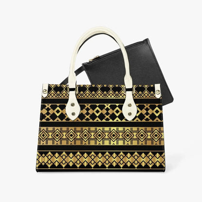 Geometric gold and black tote bag with ivory handles and black inner pouch on white background