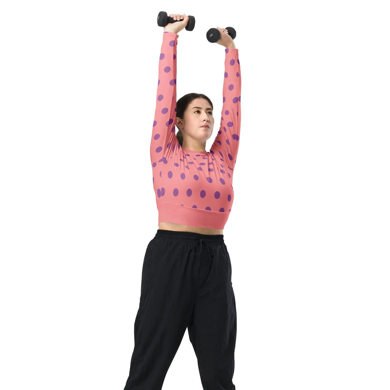 Woman in apricot polka dot long sleeve crop top lifting dumbbells, Ivorynn fitness fashion