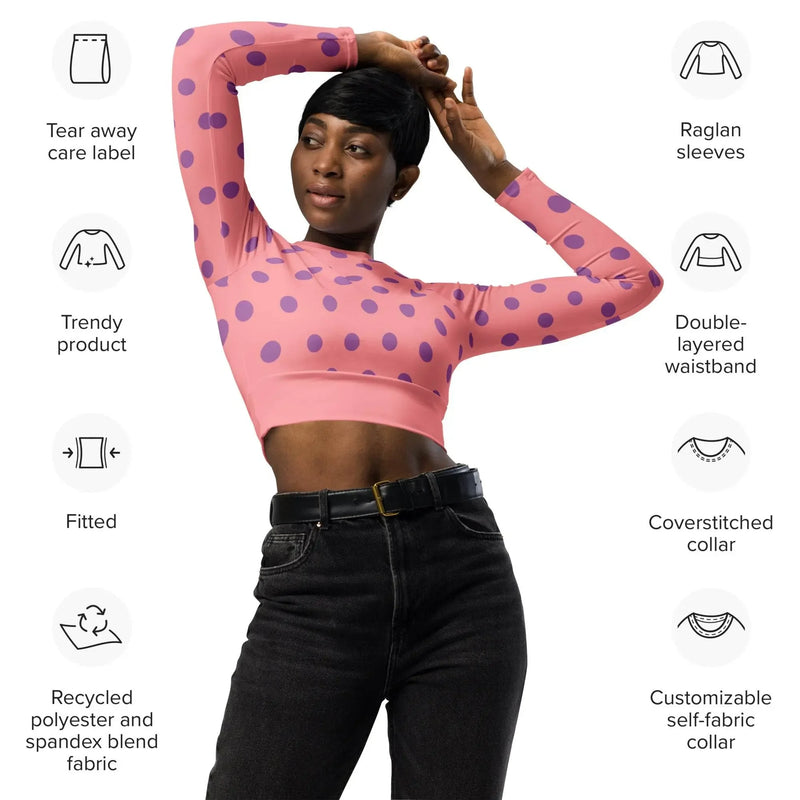Woman modeling apricot crop top with purple dots, long sleeves, and black jeans from Ivorynn
