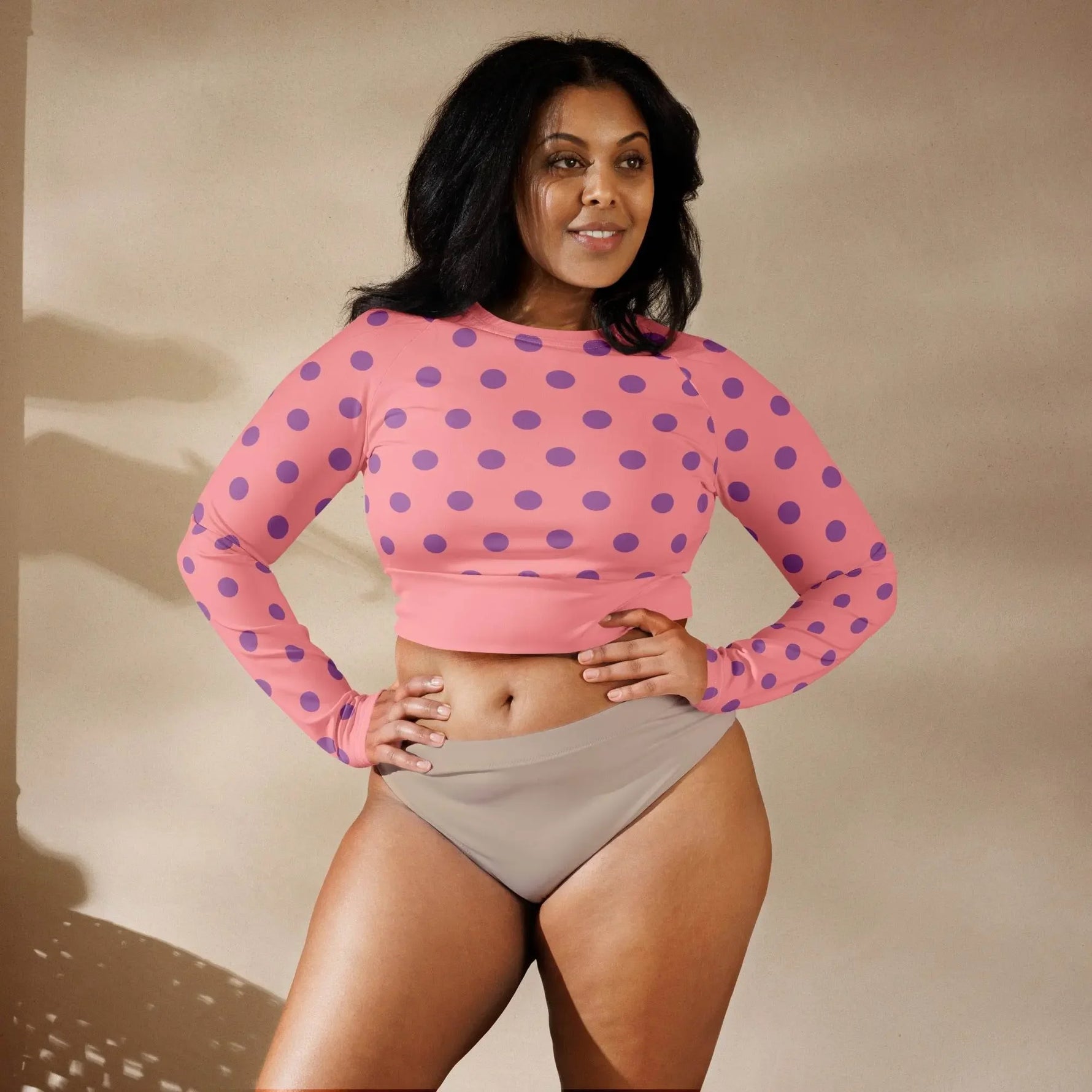 Woman wearing apricot long sleeve crop top with purple polka dots by Ivorynn