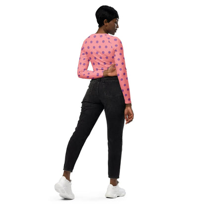 Woman modeling apricot long sleeve polka dot crop top and black jeans from Ivorynn fashion.