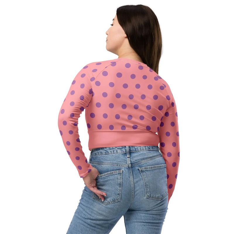 Woman in apricot pink long sleeve crop top with purple dots and blue jeans, IVORYNN fashion
