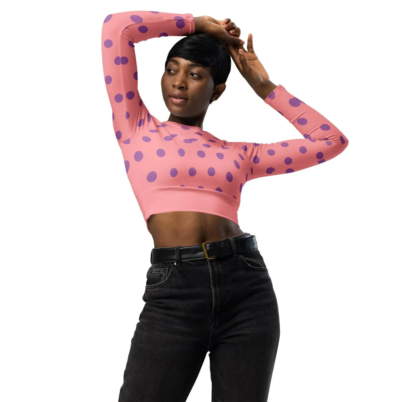 Woman modeling pink crop top with purple polka dots and black jeans from Ivorynn