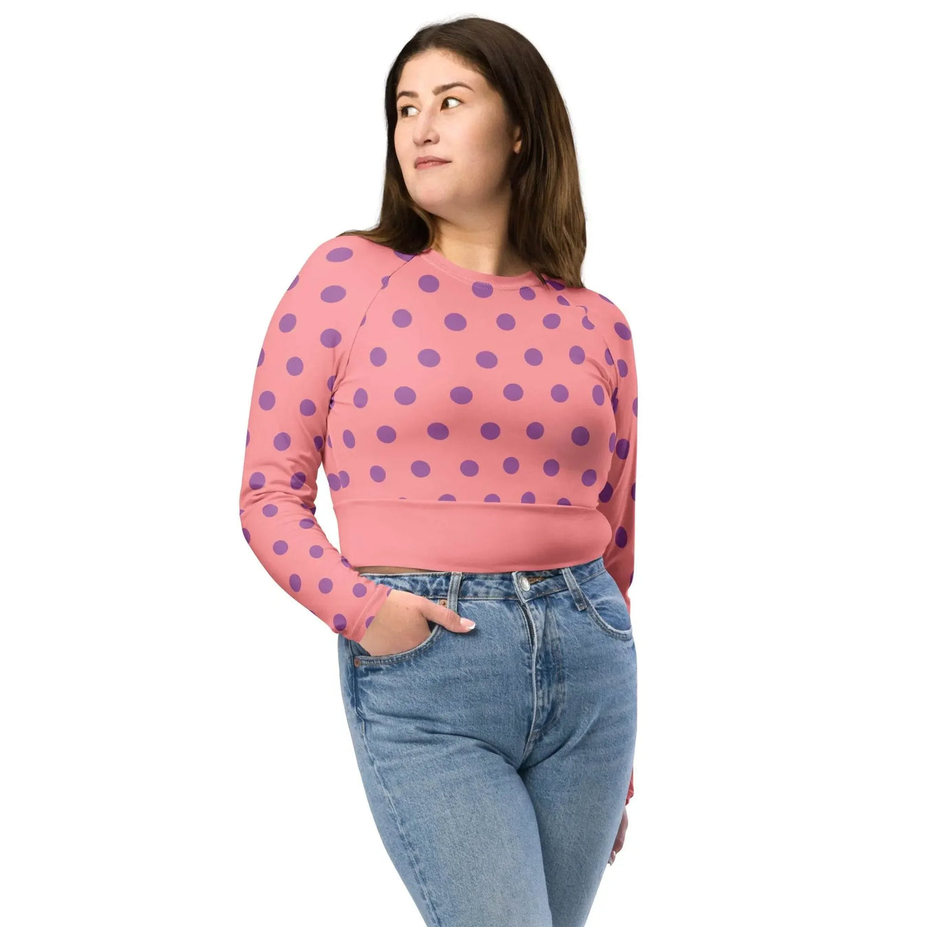 Woman modeling apricot polka dot long sleeve crop top with high-waisted jeans, Ivorynn fashion