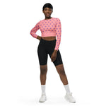 Woman wearing pink polka dot long sleeve crop top and black shorts from IVORYNN
