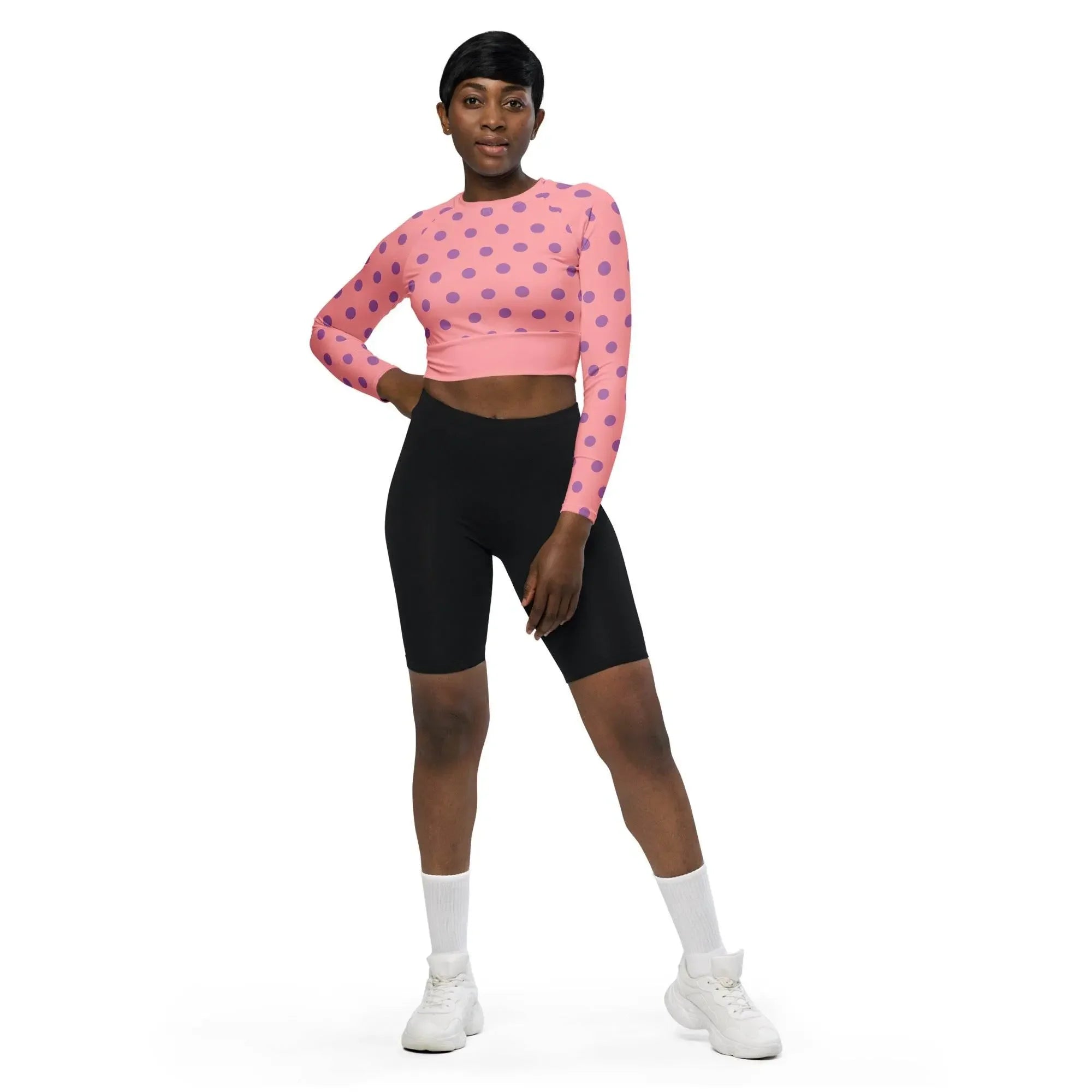 Woman wearing pink polka dot long sleeve crop top and black shorts from IVORYNN
