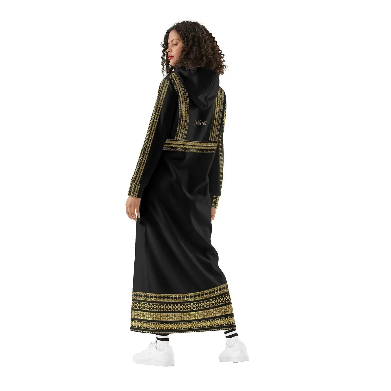 Woman modeling IVORYNN elegant black casual long hoodie dress with gold trim, white sneakers
