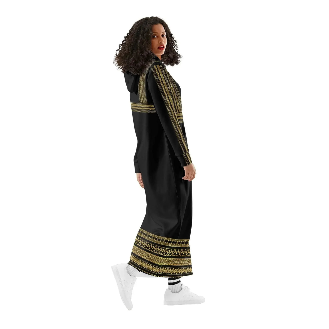 Woman wearing a black long hoodie dress with gold accents, white sneakers, at Ivorynn