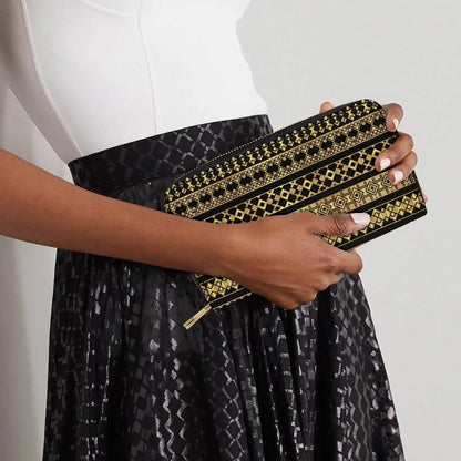 Woman holding black wallet with gold Palestinian geometric patterns, modern fashion accessory