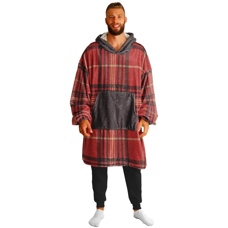 Man wearing oversized red plaid cozy hoodie with front pocket, black pants, and white socks