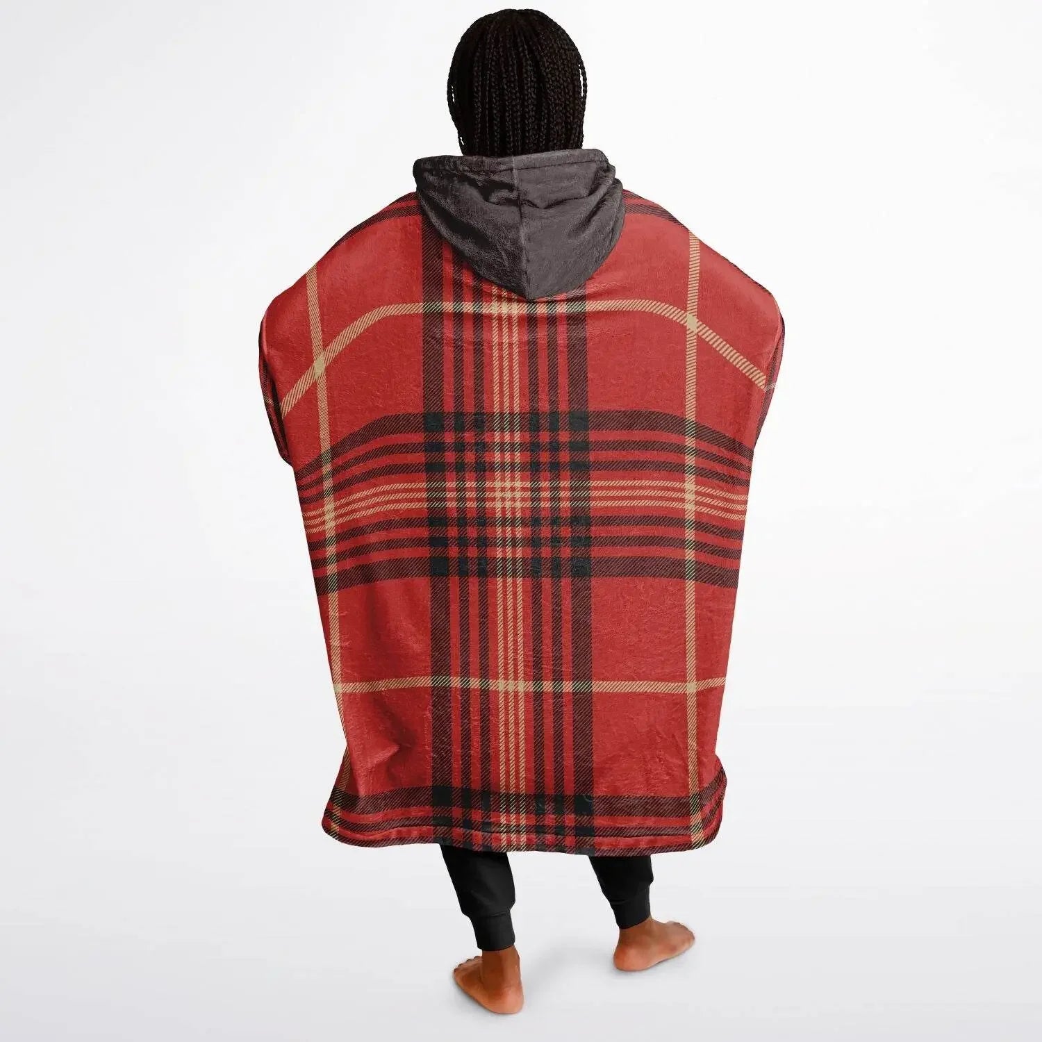 Woman wearing oversized red plaid cozy hoodie with gray hood, standing barefoot on white background