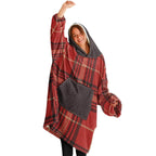 Woman in oversized red plaid cozy hoodie with hood and large pocket, smiling and posing