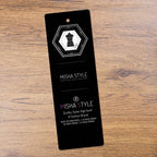 Black Misha Style clothing tag with geometric dress icon on wood surface, fashion brand label.