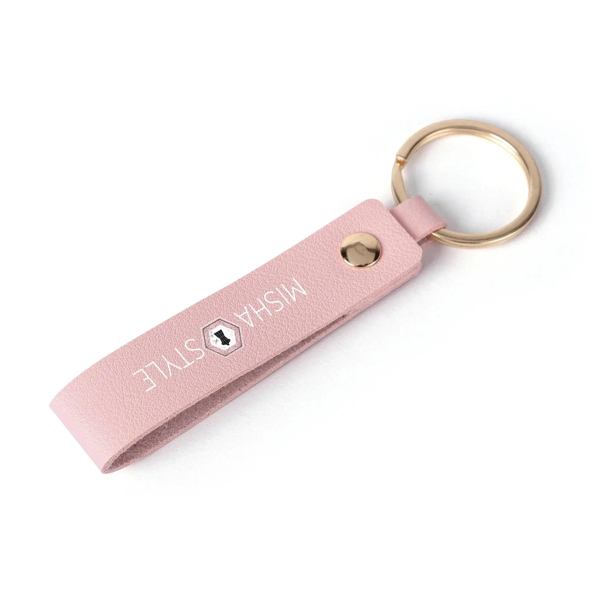 Pink leather keychain with gold ring and MISHA STYLE logo on white background