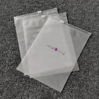 Three clear MISHA STYLE zipper bags on textured gray carpet