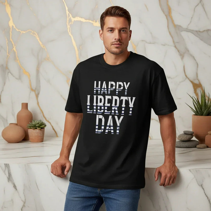 Athletic man in casual jeans and black 'Happy Liberty Day' t-shirt, stylish modern decor