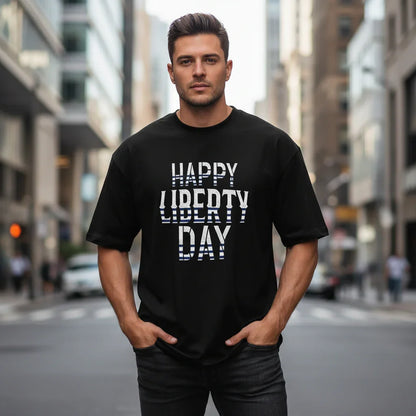 Athletic man in black 'Happy Liberty Day' t-shirt standing on city street, Ivorynn fashion
