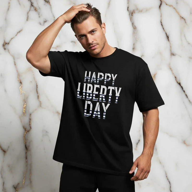Athletic man in black 'Happy Liberty Day' shirt posing, stylish men's fashion at Ivorynn