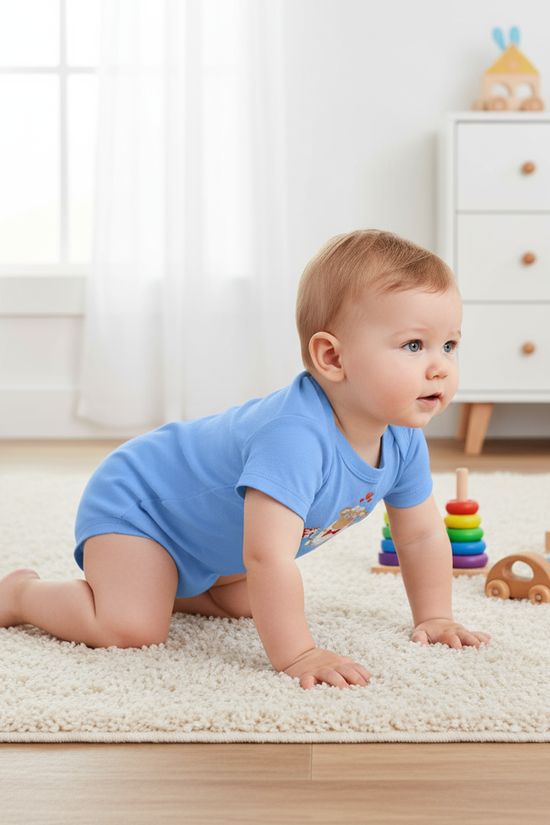 Baby boy crawling in blue onesie - back view