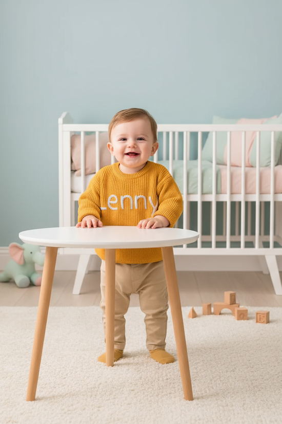 Baby boy standing in modern nursery