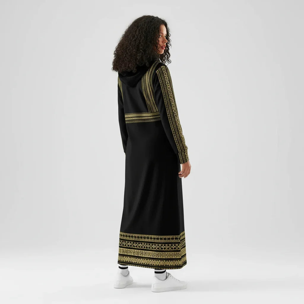 Woman in long black hooded dress with gold geometric patterns, stylish fashion from Ivorynn
