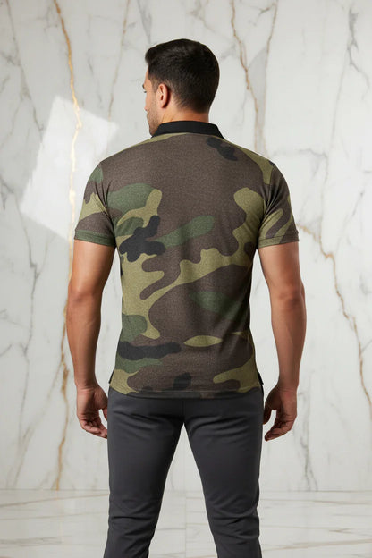 Back view of man wearing short sleeve camouflage shirt and gray pants, marble background
