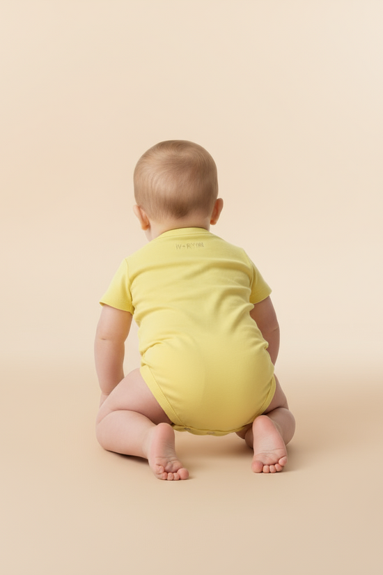 Back view of baby in yellow onesie