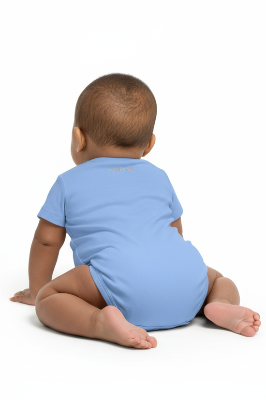 Back view of baby wearing blue IVORYNN onesie