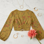 Back view on cream marble with modern geometric jewelry and coral flower