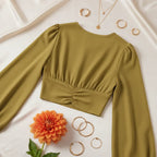 Back view on cream surface with gold hoops and orange dahlia