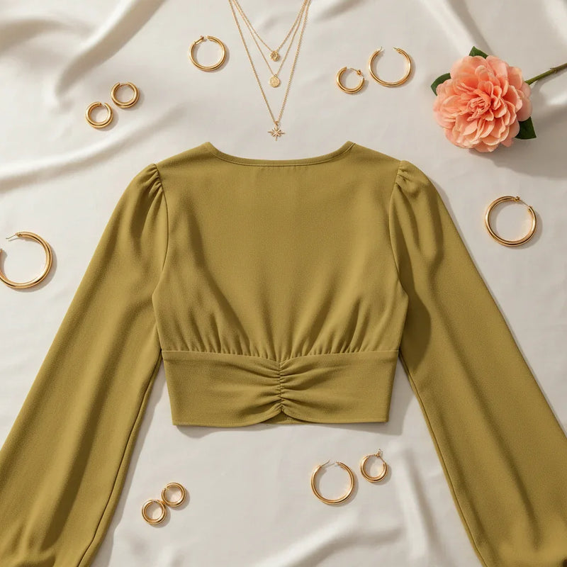 Back view on cream surface with gold hoops and peach flower