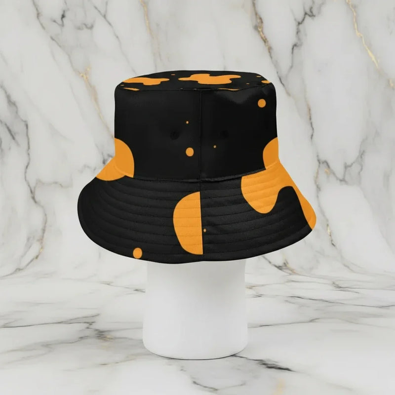 Black and orange bucket hat on mannequin with marble background at Ivorynn fashion store