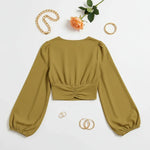 Back view on white surface with gold jewelry and peach rose