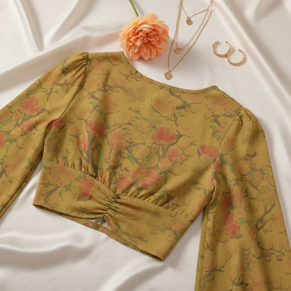 Back view with delicate gold jewelry and peach flower