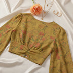 Back view with delicate gold jewelry and peach flower