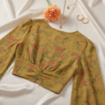 Back view with delicate gold jewelry and peach flower