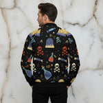Man wearing a black Halloween-themed bomber jacket with skull and potion designs, Ivorynn fashion
