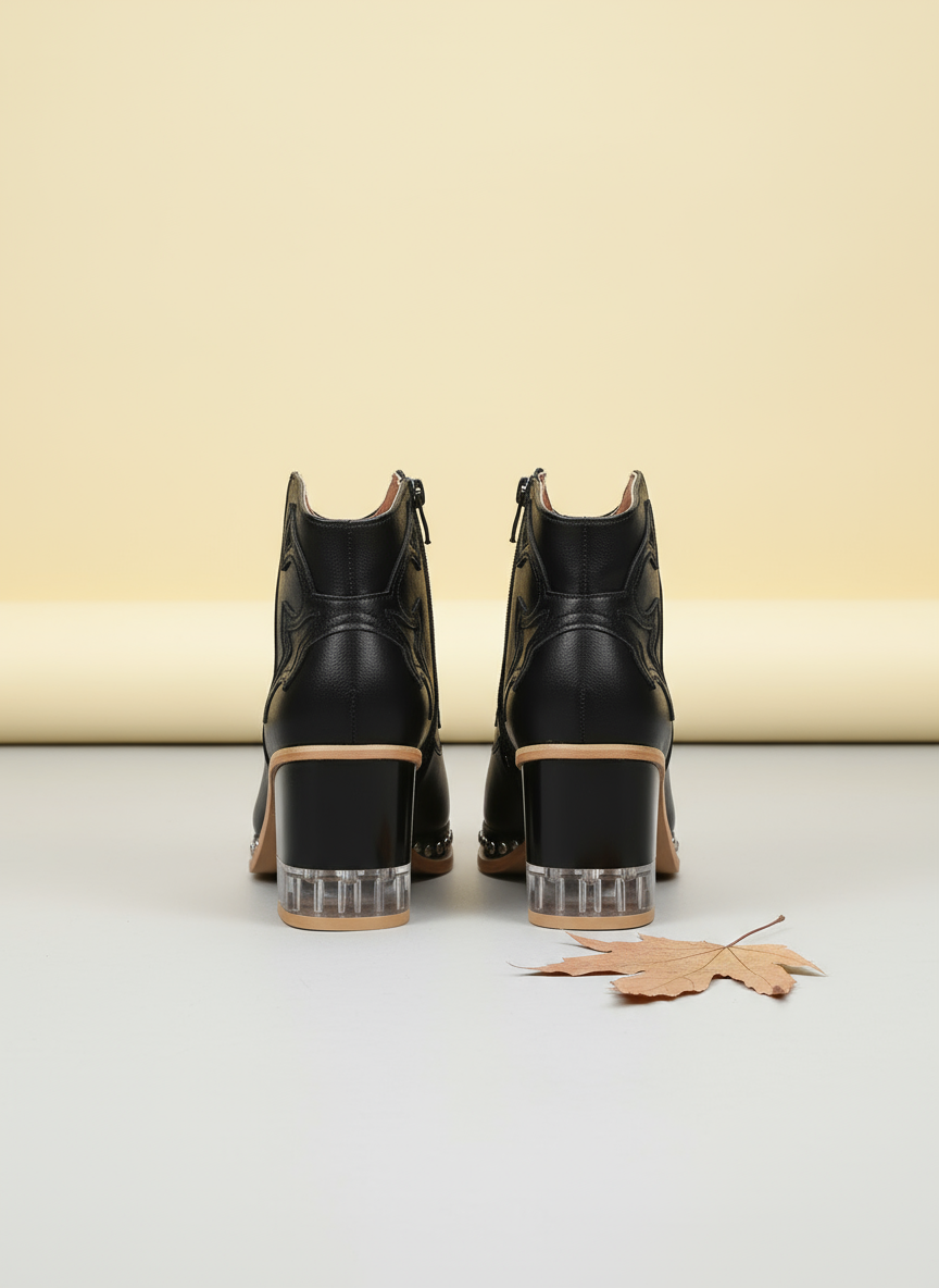 Black high-heeled shoes with clear soles on a white background