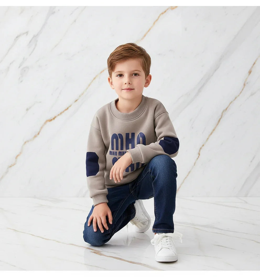 Boy kneeling looking at camera