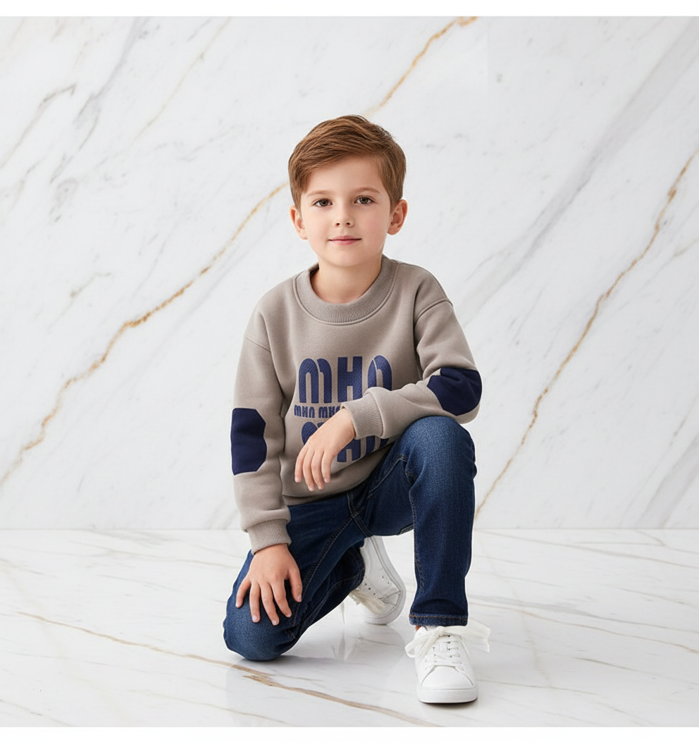 Boy kneeling looking at camera